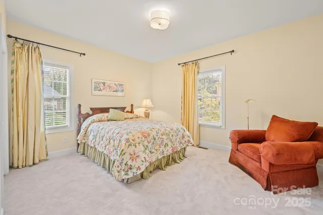 a bedroom with bed couch and window