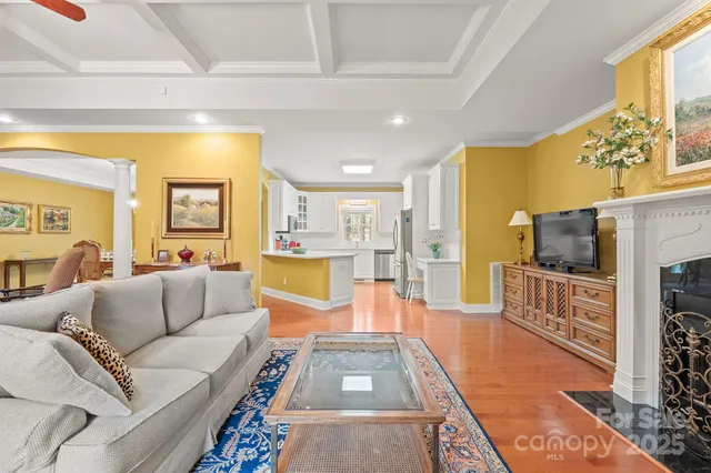 a living room with fireplace furniture and a flat screen tv