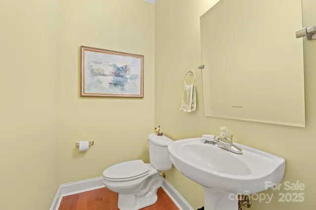 a bathroom with a sink a toilet and mirror