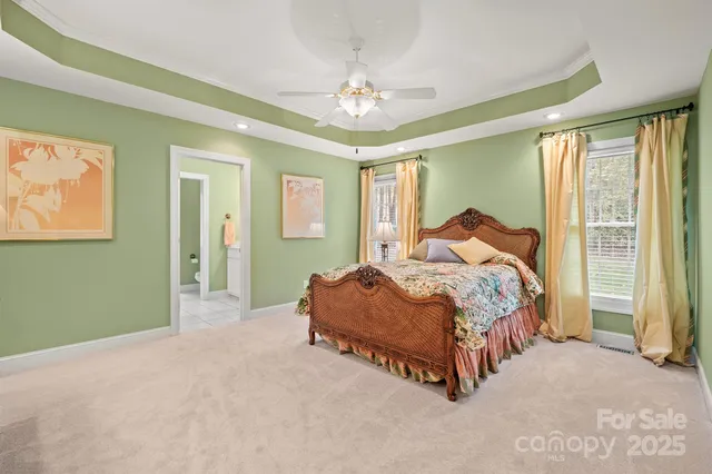 a spacious bedroom with a bed and a chandelier