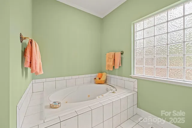 a bathroom with a tub and a window