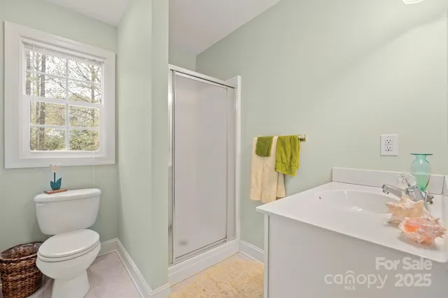 a bathroom with a sink toilet and window