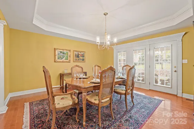 a view of a dining room with furniture and chandelier