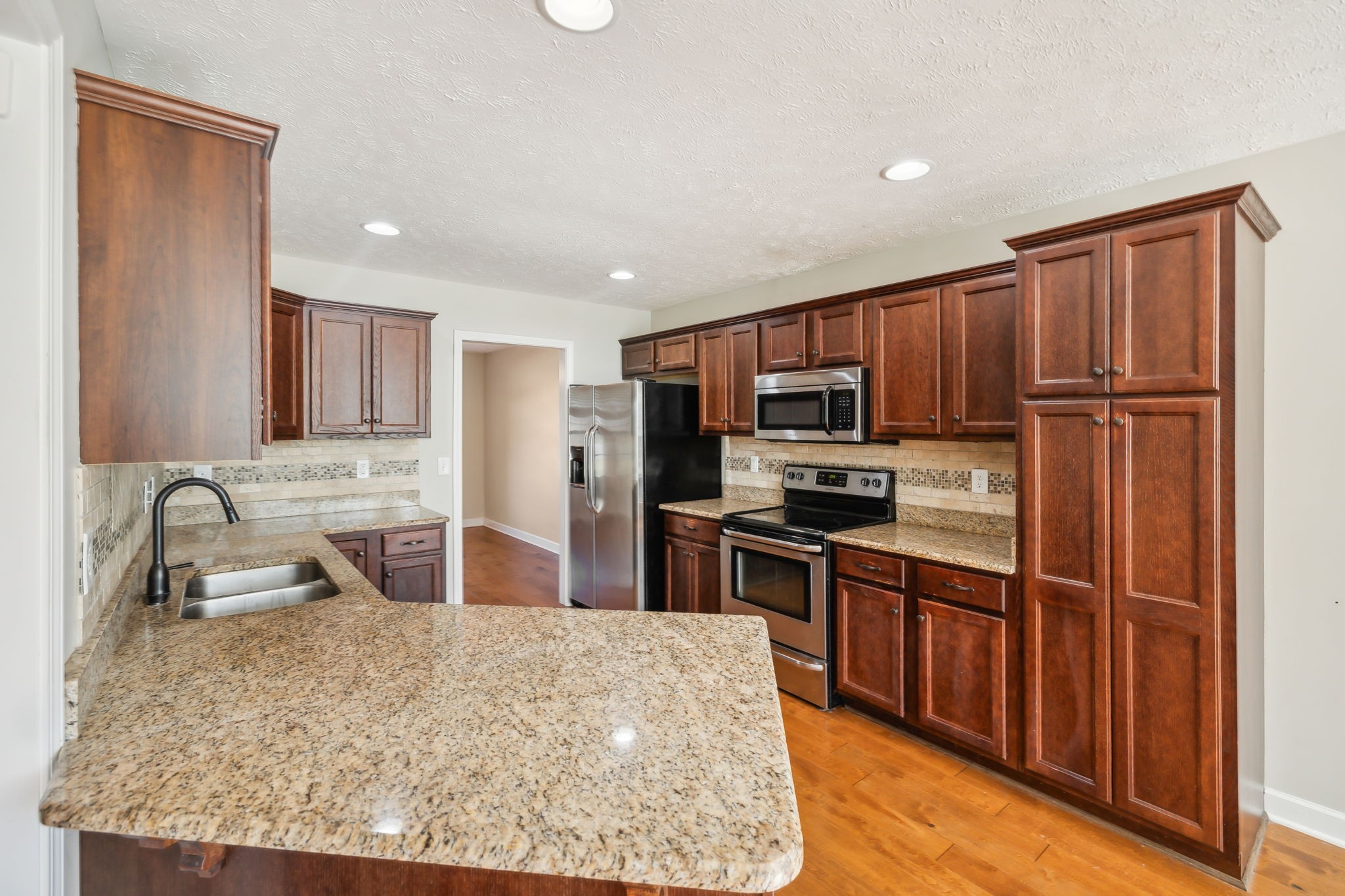 100 Riddick Court Murfreesboro, TN 37127 - Photo 11 of 56 a kitchen with stainless steel appliances granite countertop a refrigerator stove microwave and sink