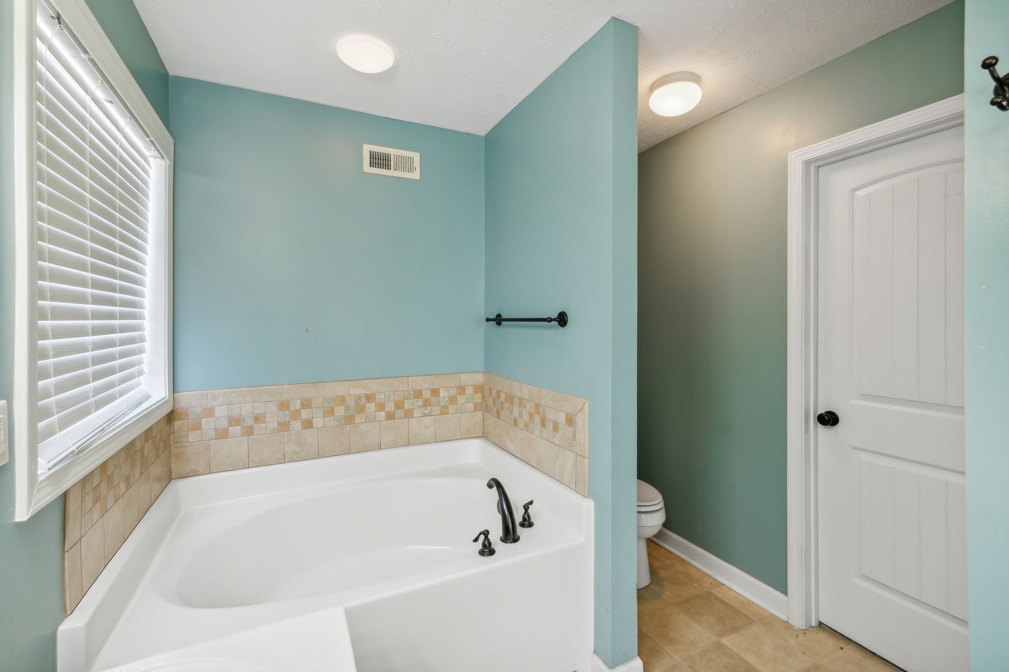 100 Riddick Court Murfreesboro, TN 37127 - Photo 26 of 56 a white bath tub sitting in a bathroom