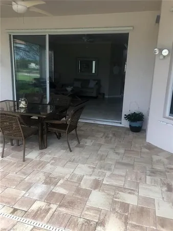 a view of a patio with a table and chairs