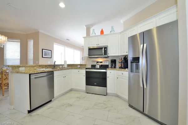 a kitchen with a refrigerator stove top oven and sink