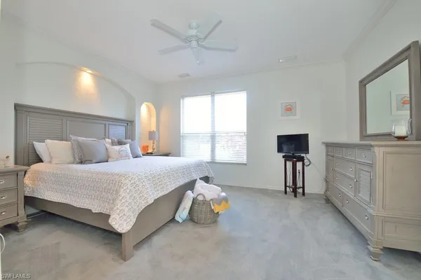 a spacious bedroom with a bed and a table