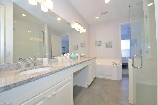 a bathroom with a granite countertop sink mirror and double