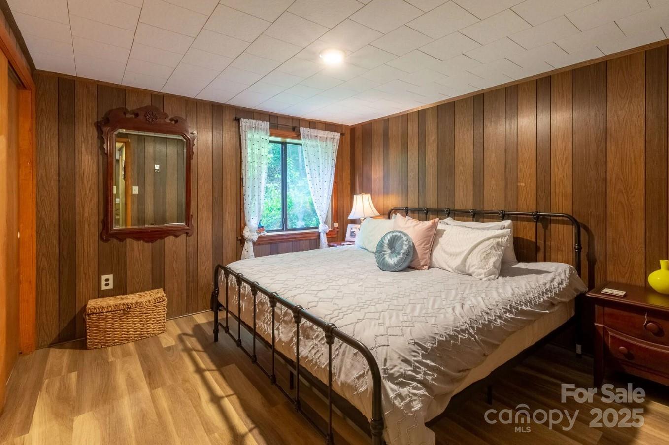 1491 Battle Branch Road Bryson City, NC 28713 - Photo 15 of 34 a bedroom with a bed and wooden floor