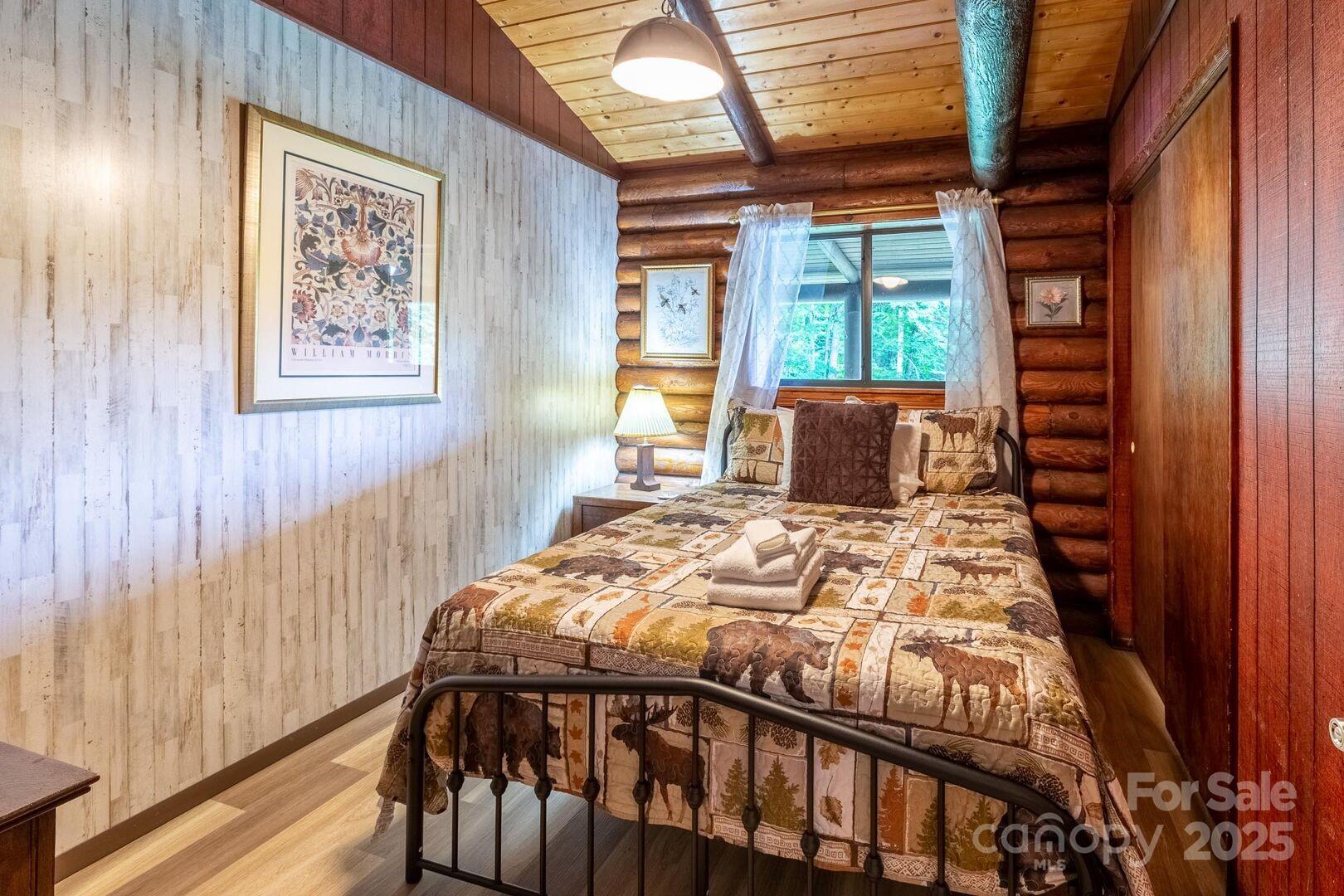 1491 Battle Branch Road Bryson City, NC 28713 - Photo 16 of 34 a bedroom with a bed and wooden floor
