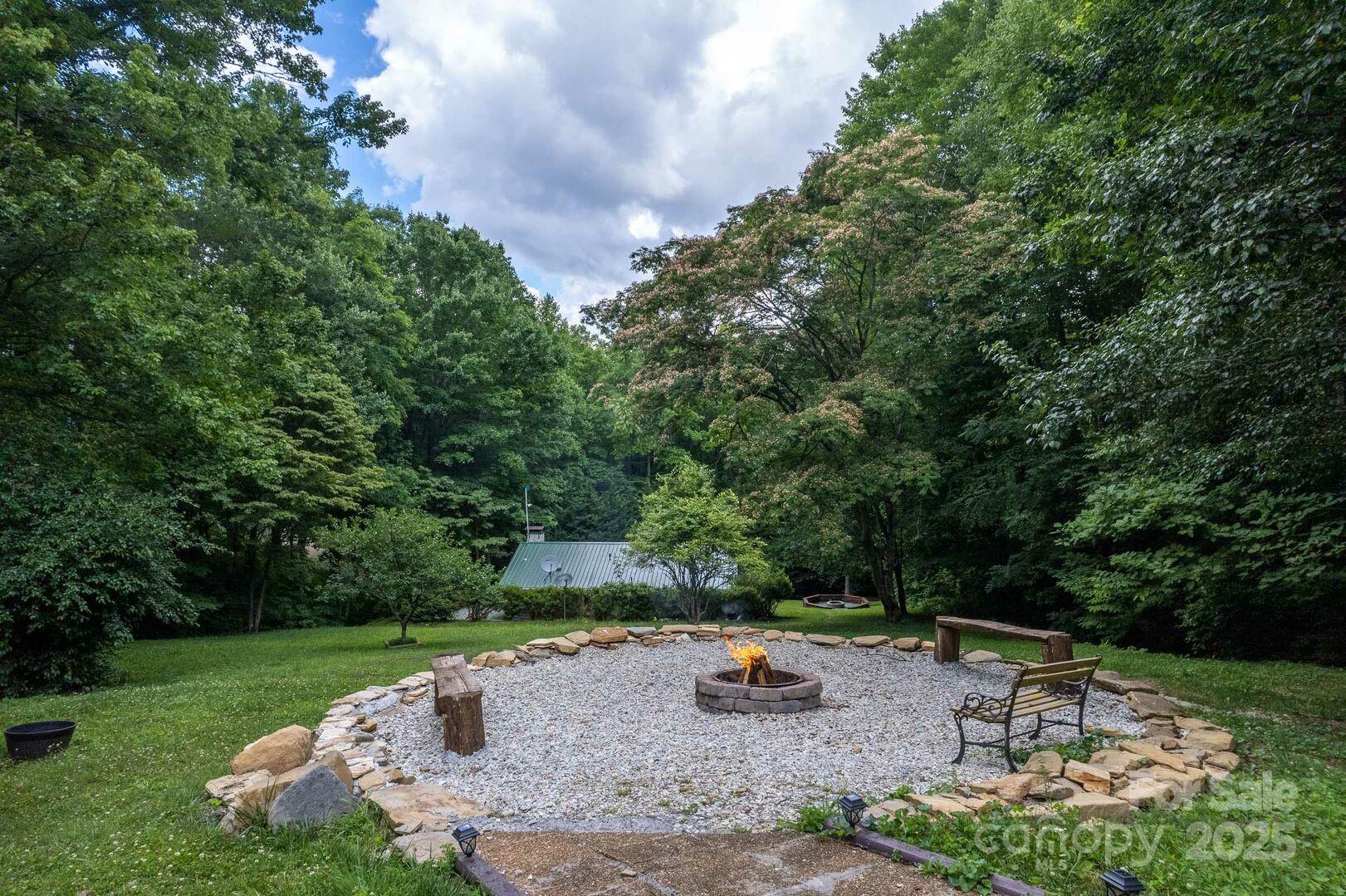 1491 Battle Branch Road Bryson City, NC 28713 - Photo 23 of 34 a view of a backyard with plants and outdoor seating