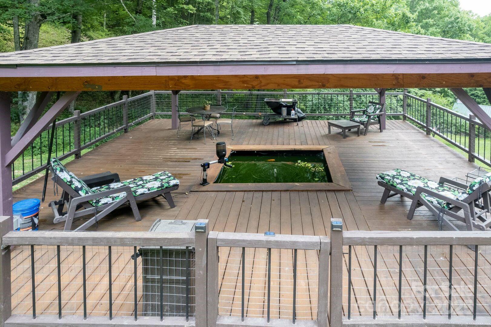 1491 Battle Branch Road Bryson City, NC 28713 - Photo 24 of 34 a view of a patio with table and chairs under an umbrella