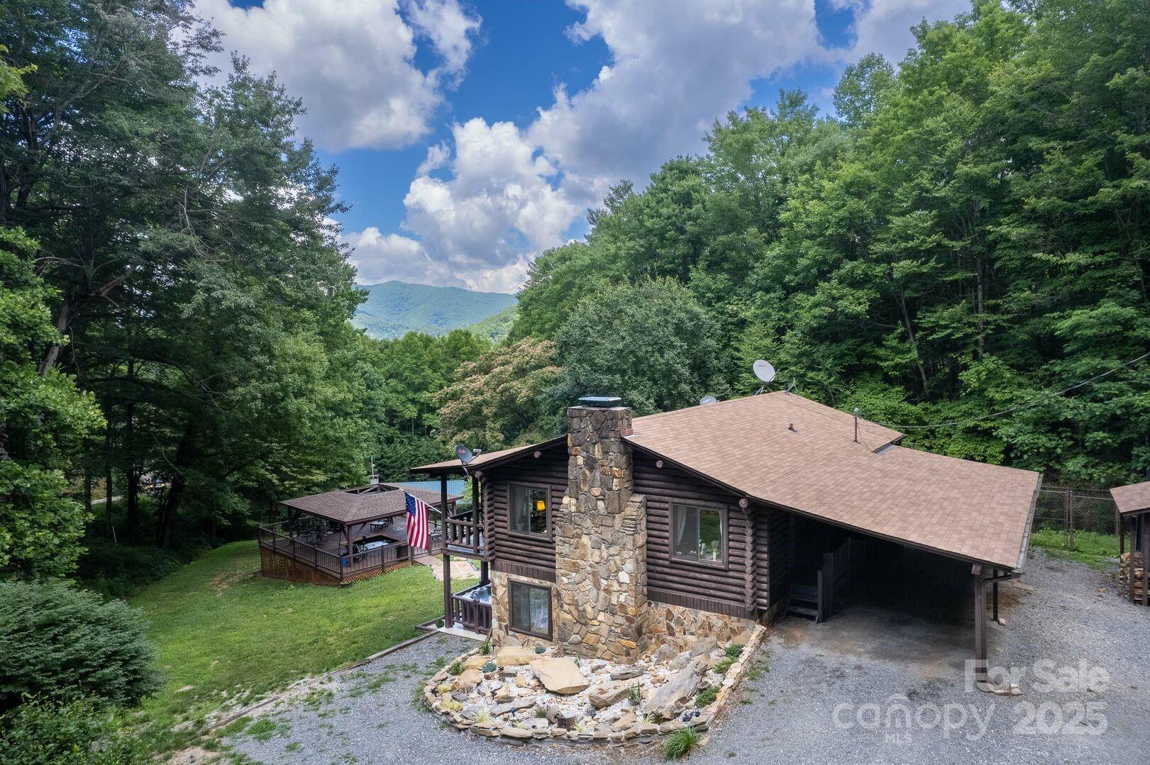 1491 Battle Branch Road Bryson City, NC 28713 - Photo 34 of 34 a backyard of a house with wooden floor barbeque oven and outdoor seating