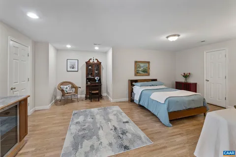 a spacious bedroom with a bed and a dresser