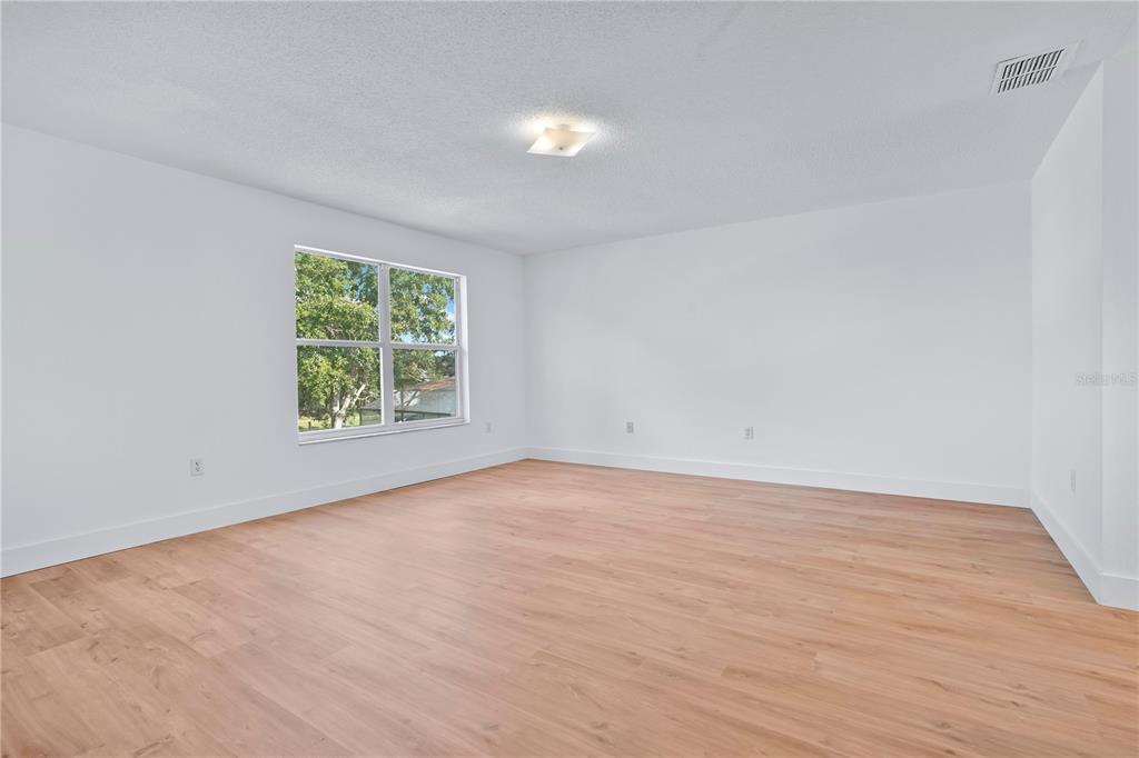 444 Acacia Tree Way Kissimmee, FL 34758 - Photo 21 of 38 an empty room with a window