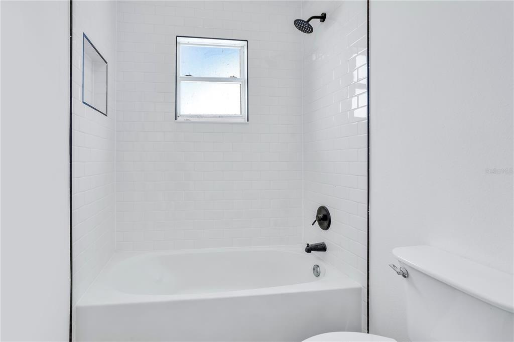 444 Acacia Tree Way Kissimmee, FL 34758 - Photo 24 of 38 a bathroom with a bathtub