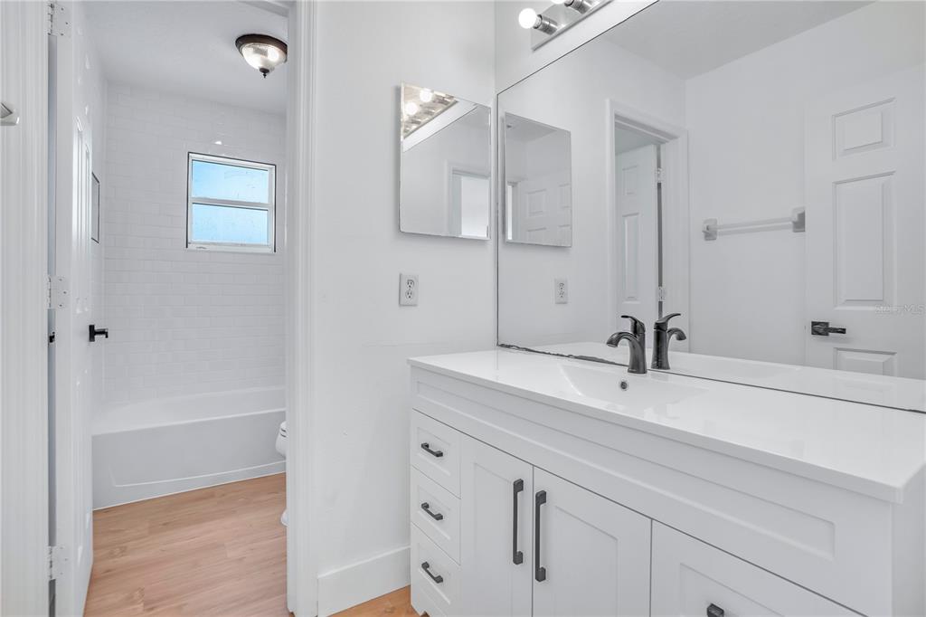 444 Acacia Tree Way Kissimmee, FL 34758 - Photo 25 of 38 a bathroom with a sink and a mirror
