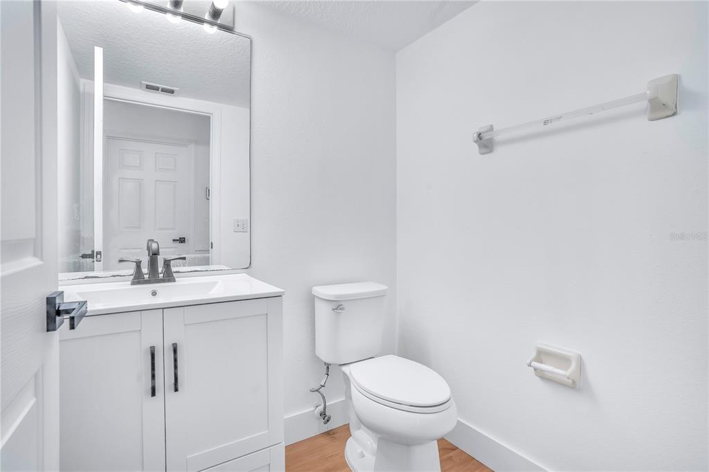 444 Acacia Tree Way Kissimmee, FL 34758 - Photo 28 of 38 a bathroom with a sink a toilet and mirror