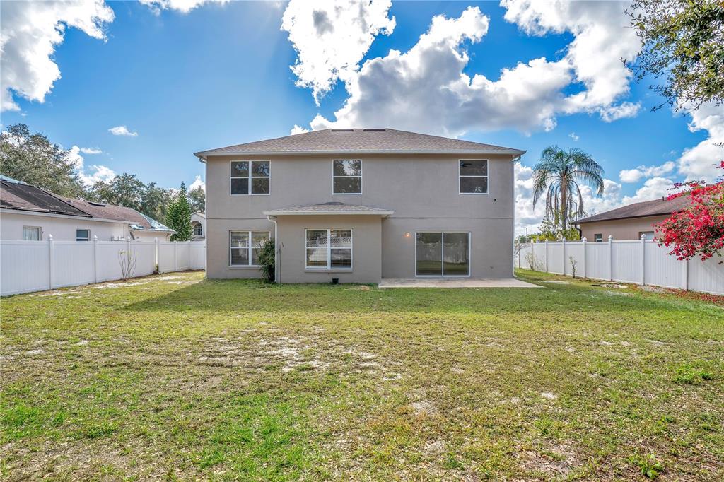 444 Acacia Tree Way Kissimmee, FL 34758 - Photo 30 of 38 a front view of a house with a garden
