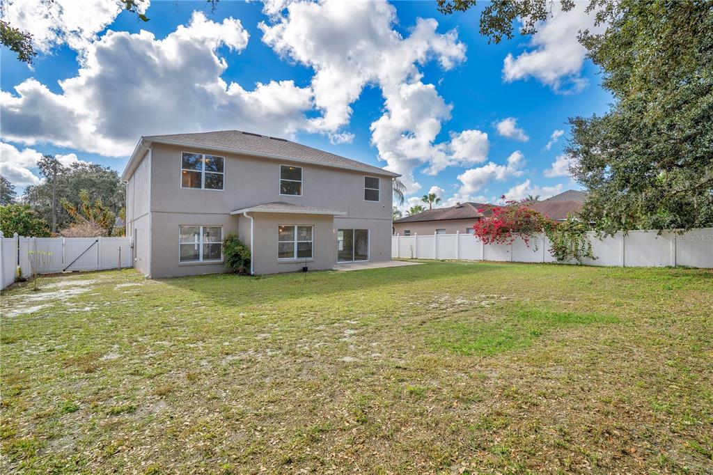 444 Acacia Tree Way Kissimmee, FL 34758 - Photo 31 of 38 a view of a house with a yard