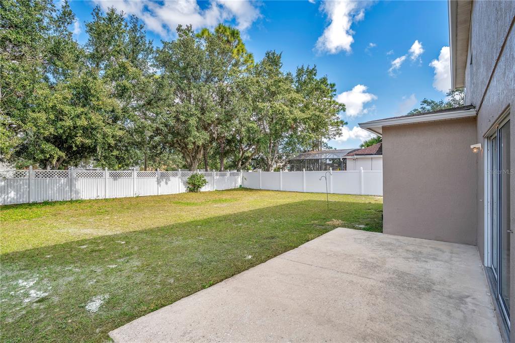 444 Acacia Tree Way Kissimmee, FL 34758 - Photo 32 of 38 a view of a house with a backyard