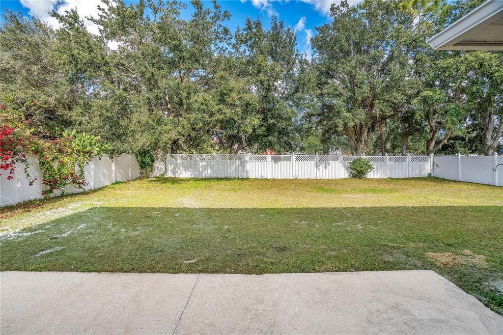 444 Acacia Tree Way Kissimmee, FL 34758 - Photo 33 of 38 a view of a swimming pool with an outdoor seating and a yard