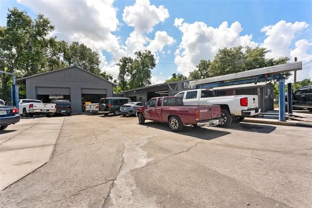 a view of cars parked in front of a house