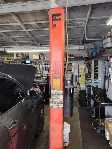 a backyard of a house with barbeque oven table and chairs