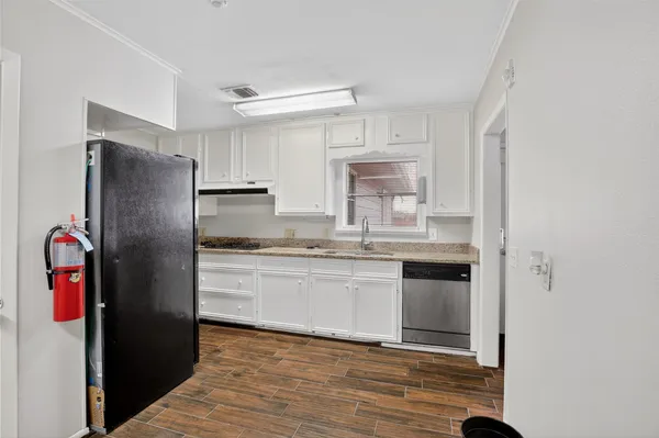 a view of empty room with wooden floor and cabinet