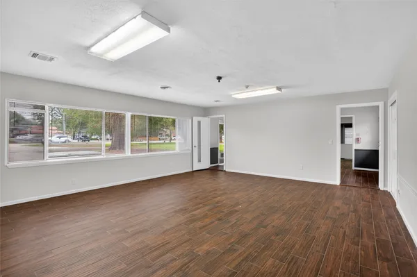 a view of a room with wooden floor