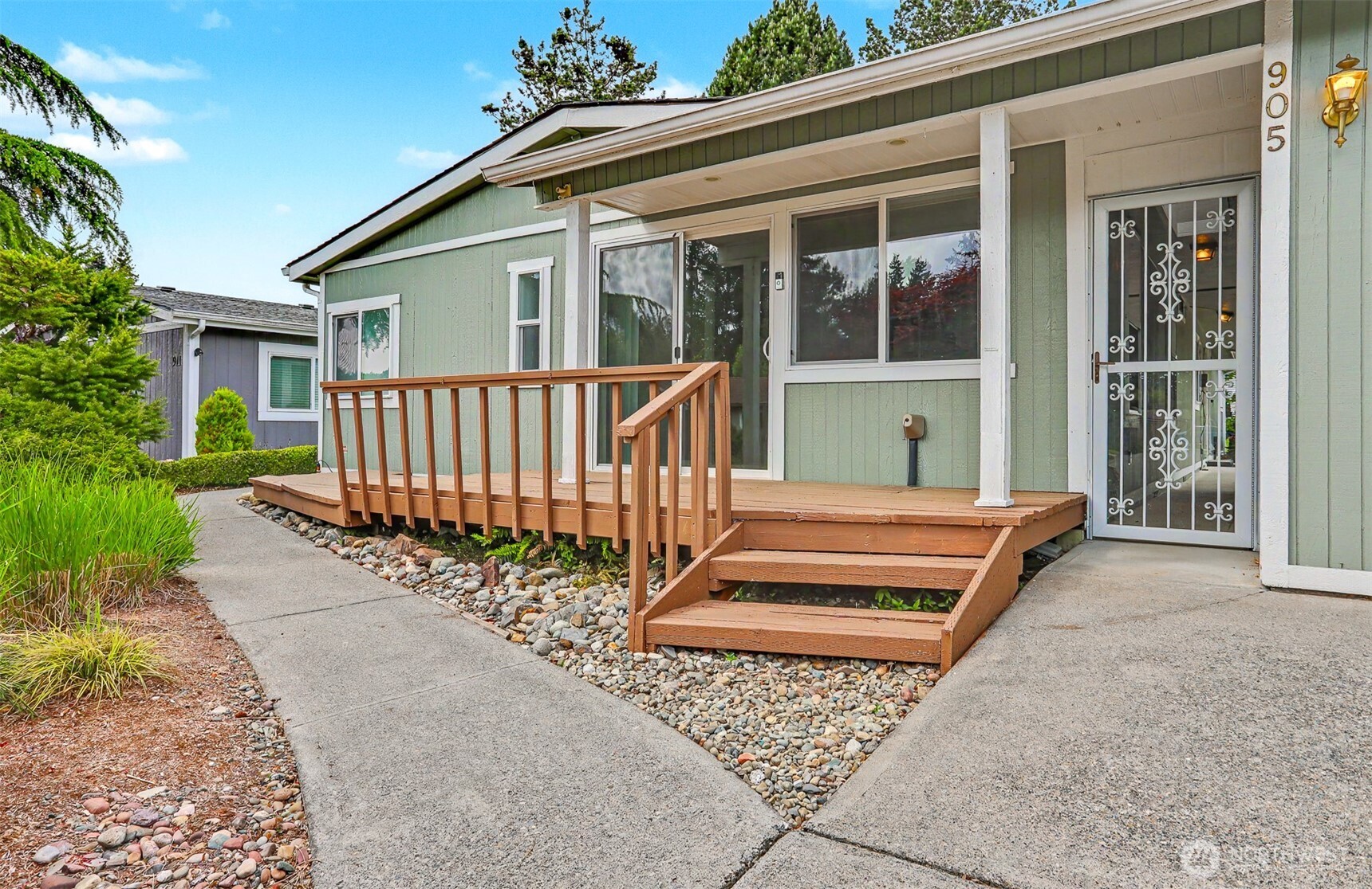 905 243rd Street Southwest Bothell, WA 98021 - Photo 24 of 37 a view of a house with a small yard and plants