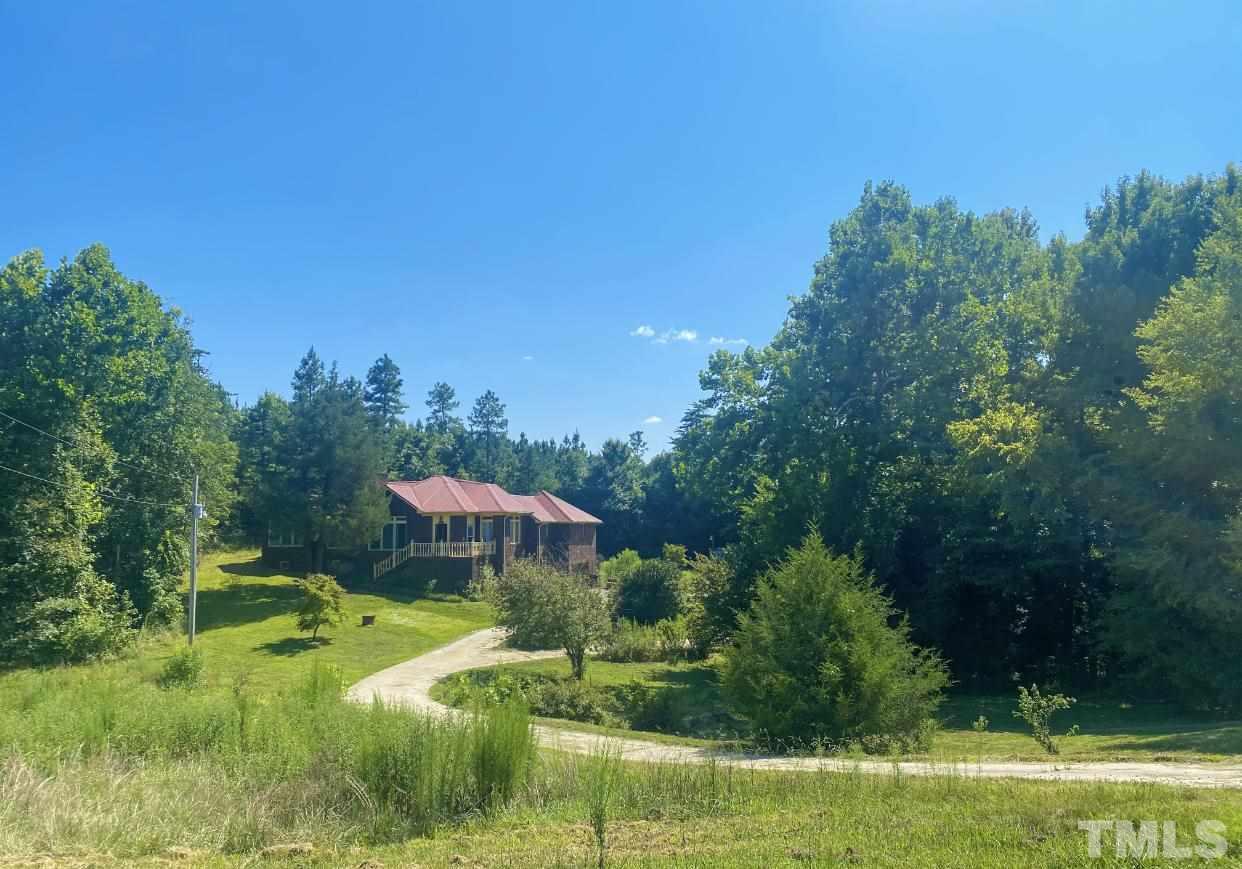 105 Lawson Farm Road Roxboro, NC 27574 - Photo 1 of 25 a view of a garden with a table and chairs