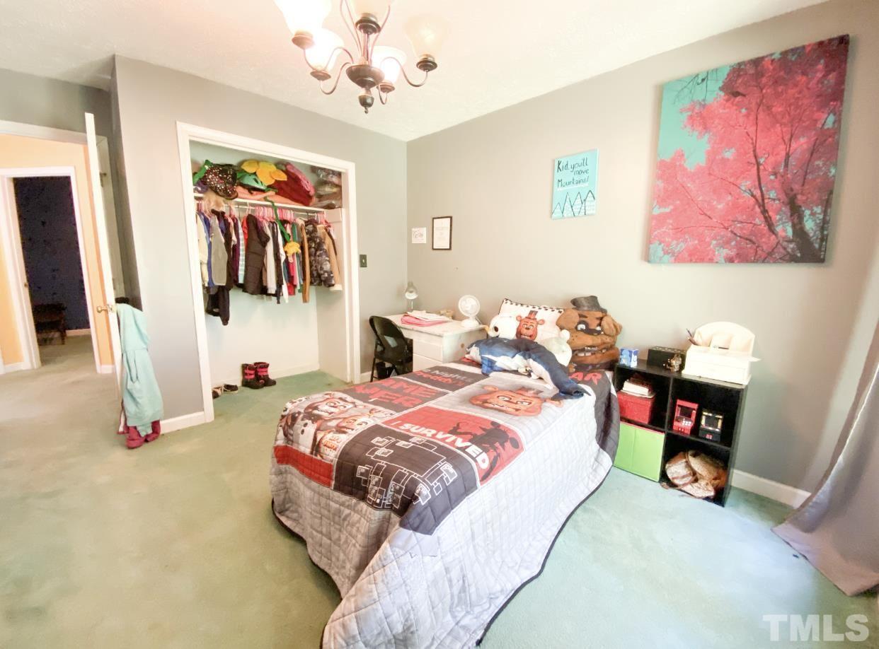 105 Lawson Farm Road Roxboro, NC 27574 - Photo 14 of 25 a bed room with a bed and a wall painting