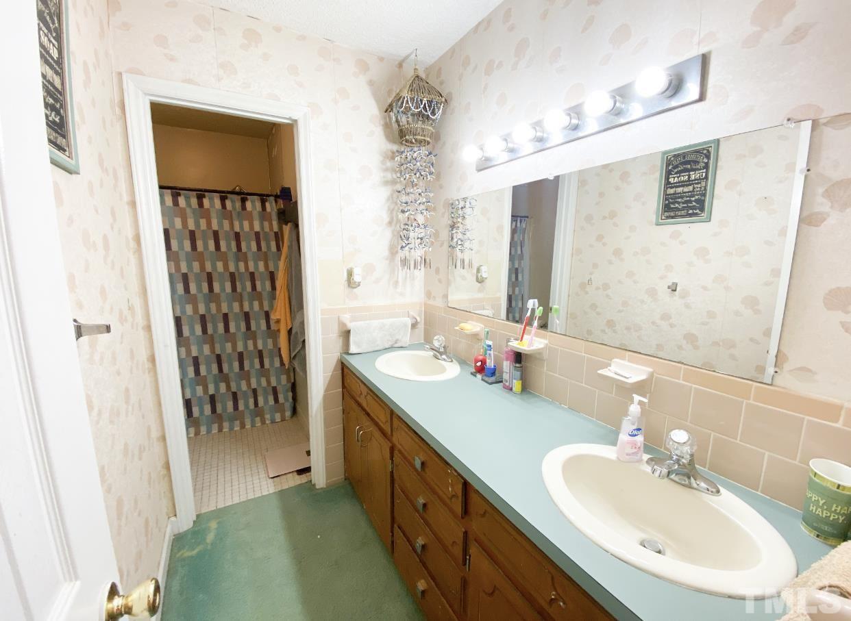 105 Lawson Farm Road Roxboro, NC 27574 - Photo 15 of 25 a bathroom with a double vanity sink and a mirror