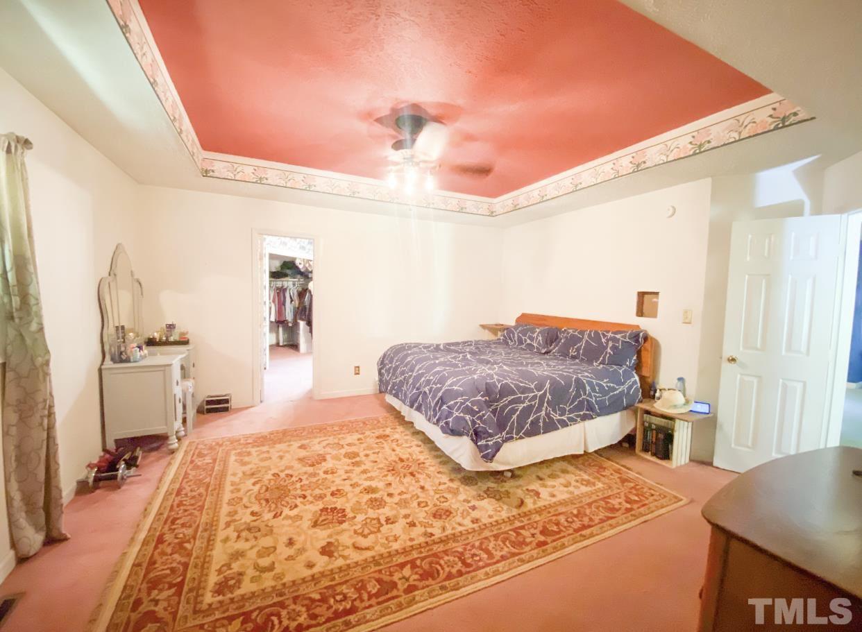 105 Lawson Farm Road Roxboro, NC 27574 - Photo 18 of 25 a bedroom with a bed and wooden floor