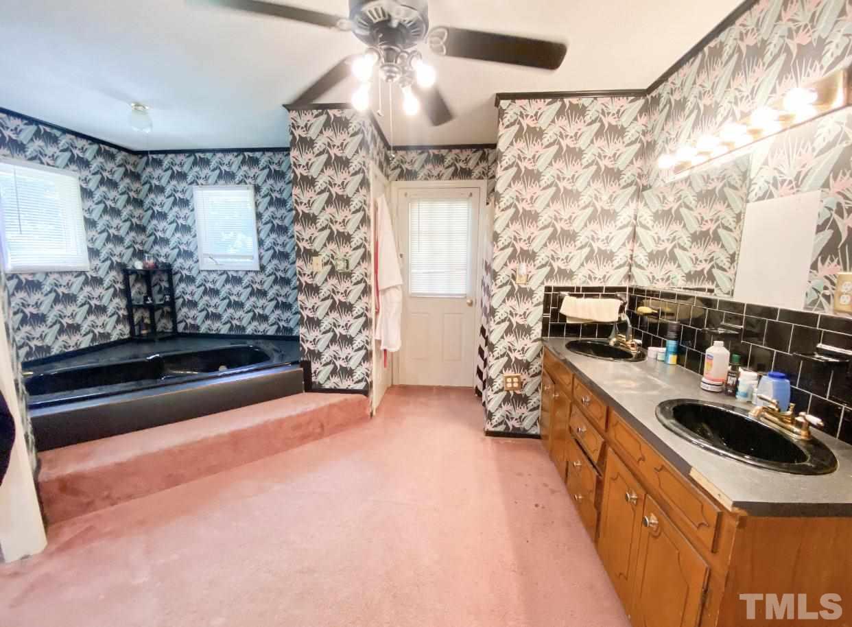 105 Lawson Farm Road Roxboro, NC 27574 - Photo 20 of 25 a kitchen with stainless steel appliances granite countertop a stove a sink and a refrigerator