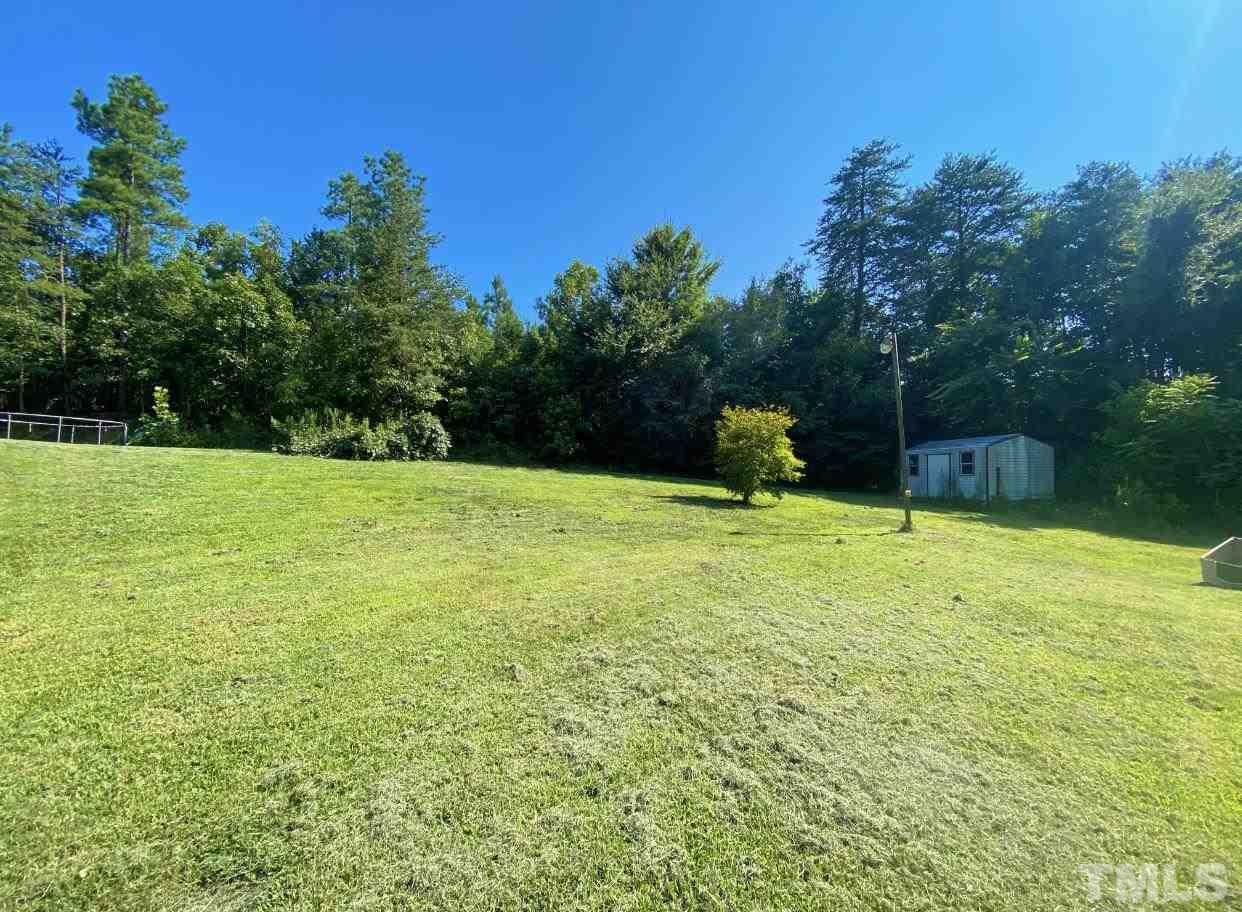 105 Lawson Farm Road Roxboro, NC 27574 - Photo 25 of 25 a view of a garden with a bench