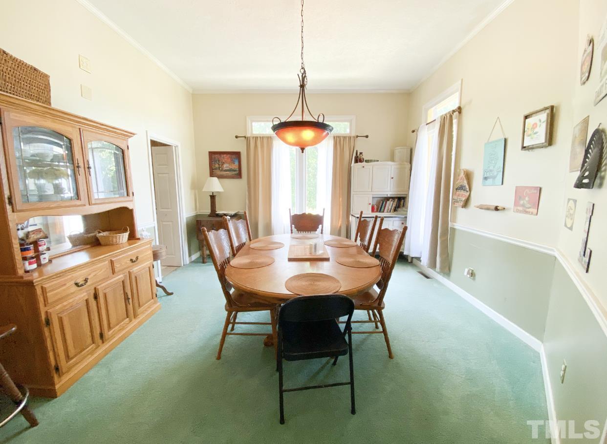 105 Lawson Farm Road Roxboro, NC 27574 - Photo 5 of 25 a dining room with furniture a chandelier and wooden floor