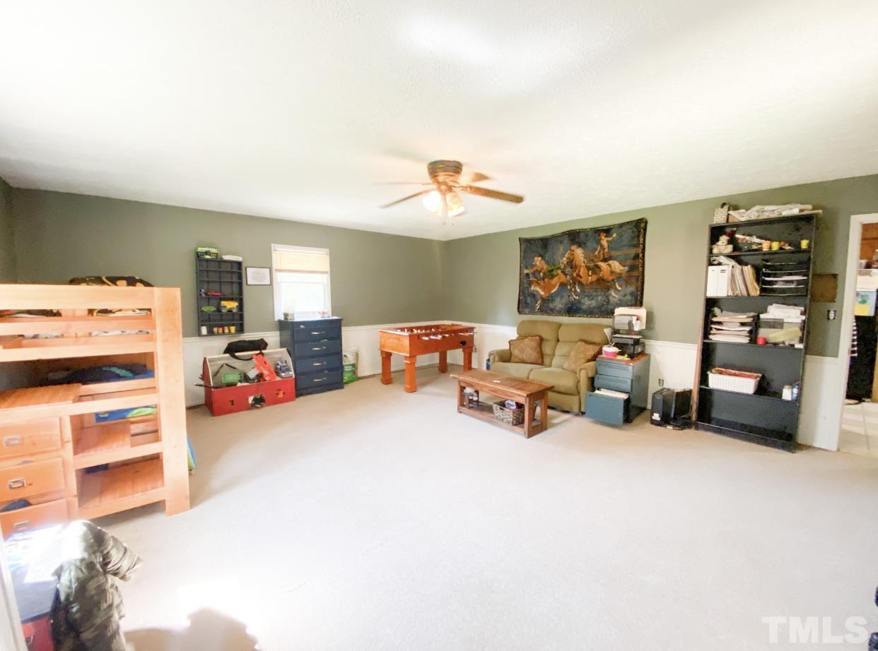 105 Lawson Farm Road Roxboro, NC 27574 - Photo 10 of 25 a living room with furniture and a chandelier
