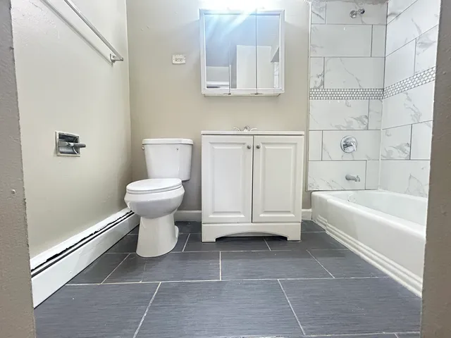 a bathroom with a toilet a sink and bathtub