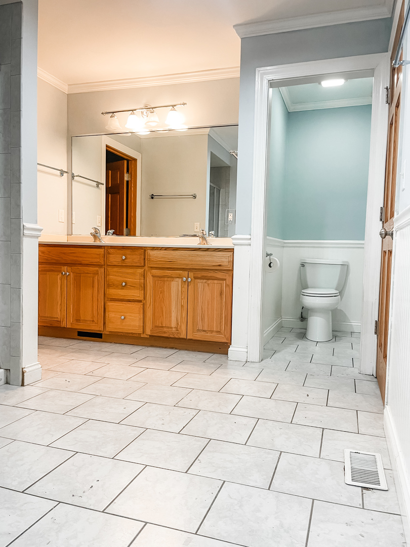 1308 Axcel Lane Sycamore, IL 60178 - Photo 27 of 40 a bathroom with a sink a mirror and a toilet