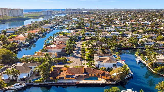 an aerial view of residential houses with outdoor space and swimming pool