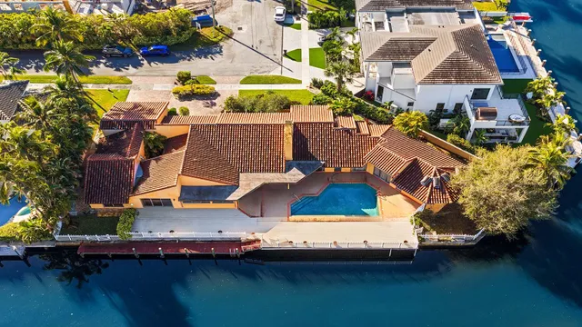 an aerial view of a house with a yard pool patio and outdoor seating