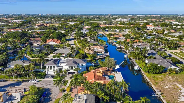 an aerial view of residential houses with outdoor space and trees