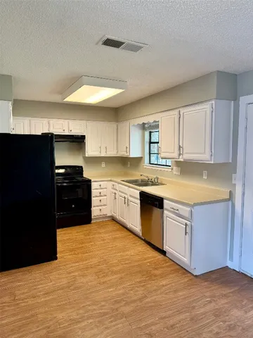 a kitchen with a stove a sink and a refrigerator