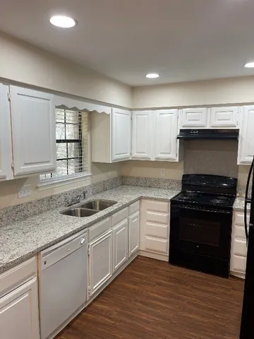 a kitchen with a sink stove and cabinets