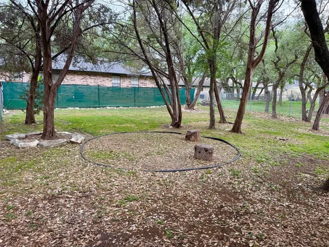 a view of a yard with a tree