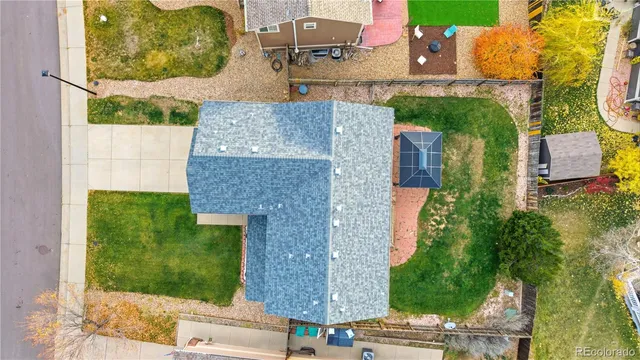 an aerial view of a house with garden space and street view
