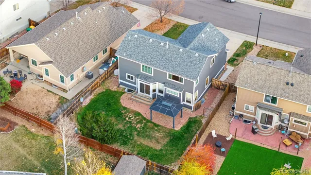 an aerial view of multiple houses with yard